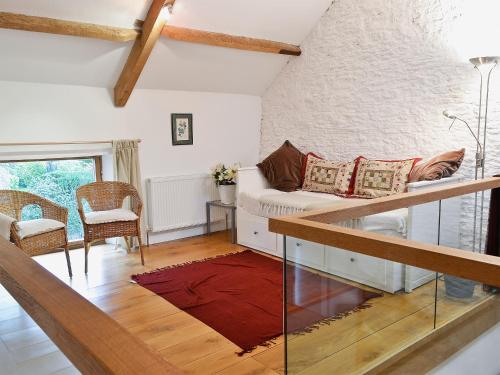 a living room with a couch and a table at Shaplands Barn in Cold Ashton