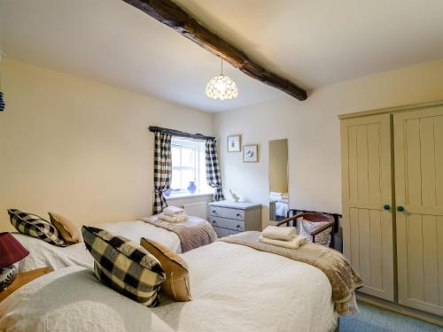 a bedroom with two beds and a chandelier at The Forge in Hawnby