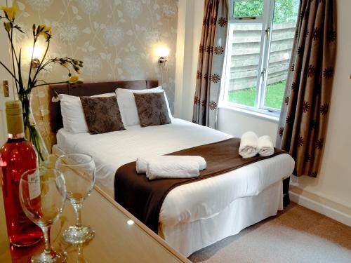 a hotel room with a bed and a window at Riverside Cottage - B6859 in Saint Cleer