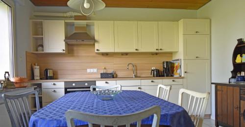 a kitchen with a table with a blue table cloth at Kreativhof Lehmberg in Hamminkeln