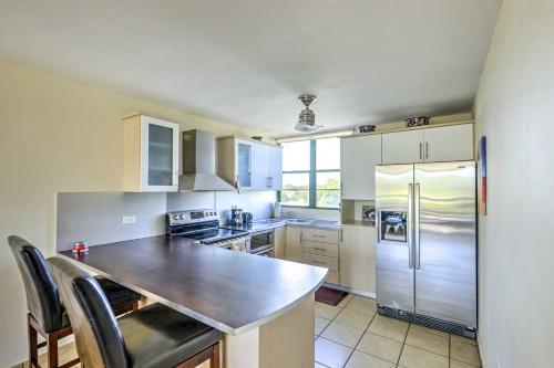 a kitchen with white cabinets and a wooden counter top at Tropical Puerto Rico Penthouse Waterpark On-Site! in Loiza
