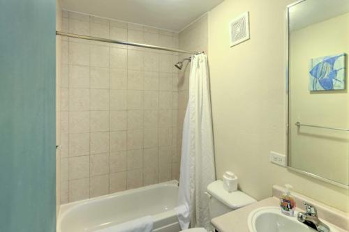a bathroom with a tub and a toilet and a sink at Tropical Puerto Rico Penthouse Waterpark On-Site! in Loiza