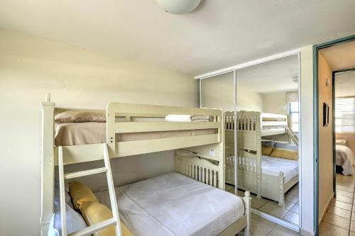 a room with two bunk beds and a mirror at Tropical Puerto Rico Penthouse Waterpark On-Site! in Loiza