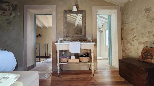 a bathroom with a white sink and a mirror at Podere Le Vedute in Larciano