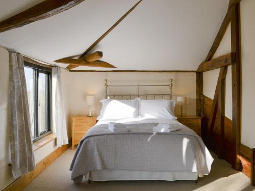 a bedroom with a bed and a ceiling fan at The Cart Lodge-e3568 in Uggeshall