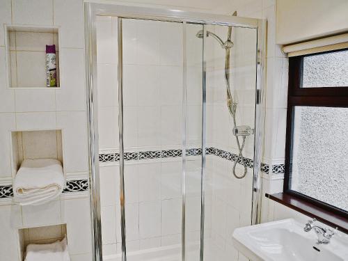 a bathroom with a shower and a sink at Riverside in Carlyon Bay