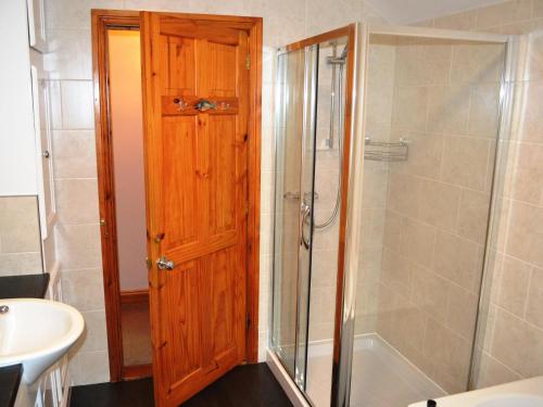 a bathroom with a shower and a toilet and a sink at Wickhams View in Keswick