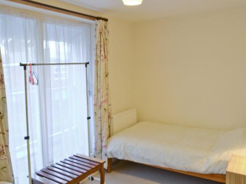 a bedroom with a bed and a large window at The Retreat in Cromer