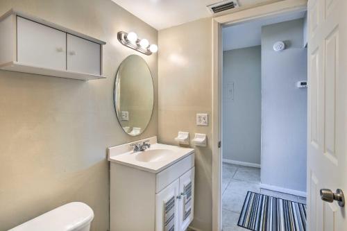 a bathroom with a sink and a mirror at Walk to Beach and Dining Sunny St Pete Condo! in St Pete Beach