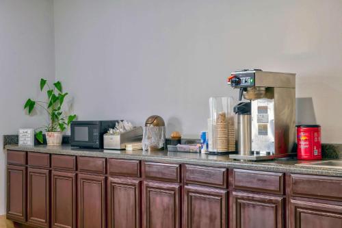 a kitchen counter with a coffee maker on top of it at Motel 6 Byron, Ga in Byron