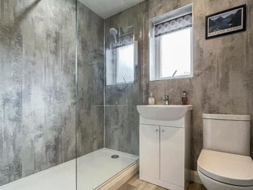 a bathroom with a shower and a toilet and a sink at Ferry View in Oban