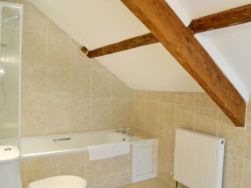 a bathroom with a toilet and a bath tub at Dolgoed House in Llangadog