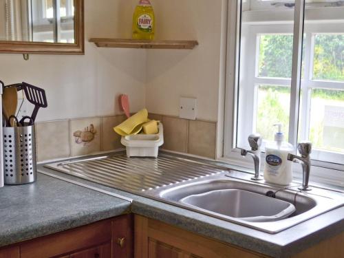 a kitchen counter with a sink and a window at The Old Post Office in Fordingbridge