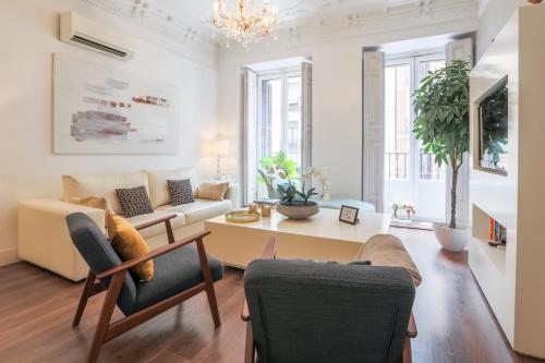 a living room with a couch and a table at Centro Madrid. Plaza Mayor. Puerta del Sol. Opera. in Madrid