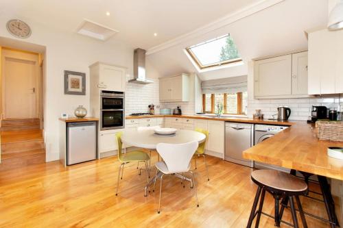a kitchen with a table and chairs in it at The Little Barn @ Bath With LARGE Hot Tub in Bath