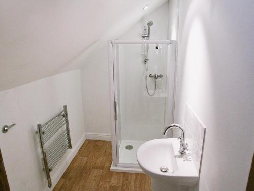 a bathroom with a shower and a sink at The Street Farm Barn in Drayton