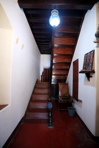 a hallway with stairs and a light on the ceiling at Srivilas in Pudunagaram