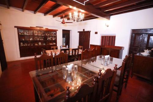 a dining room with a long table and chairs at Srivilas in Pudunagaram