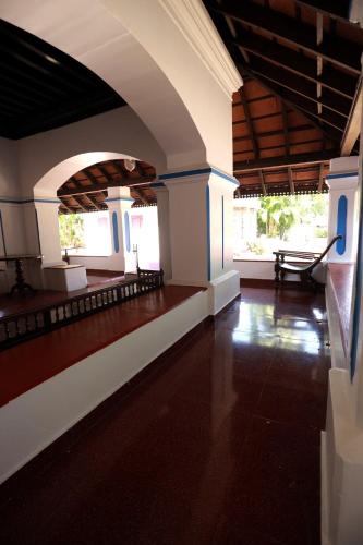 a living room with a wooden floor and a table at Srivilas in Pudunagaram