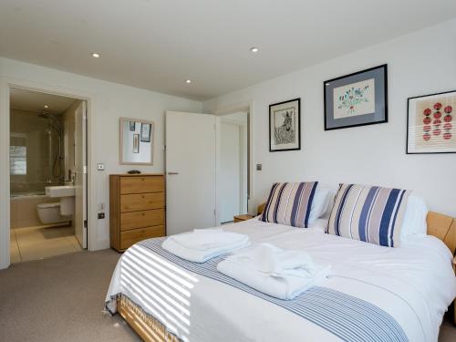 a bedroom with a bed with two towels on it at Solent Lawns in Gurnard