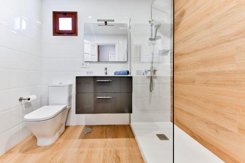 a bathroom with a toilet and a sink and a shower at Sea Moon Lanzarote in Playa Blanca