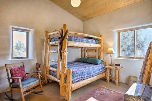 a bedroom with a bunk bed and a chair at Unique Del Norte Getaway on 50 Private Acres! in Del Norte