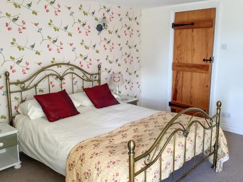 BroughにあるOld Pennistoneのベッドルーム1室(赤い枕のベッド1台付)