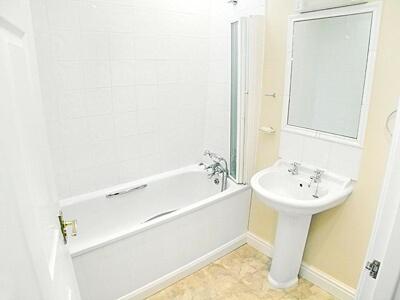 a bathroom with a sink and a tub and a toilet at Aira Cottage in Watermillock