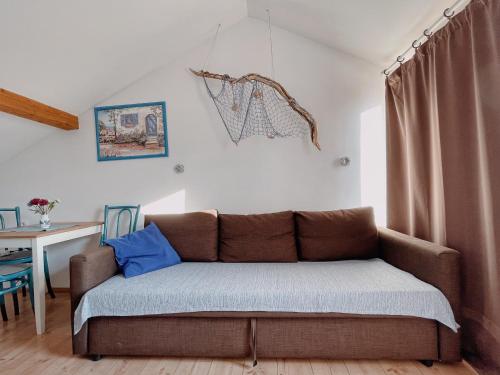 a couch with blue pillows in a living room at Apartments Zoričić in Novi Vinodolski