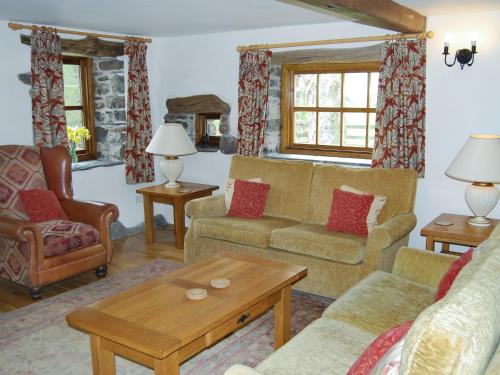 a living room with two couches and a table at The Garth in Mungrisdale