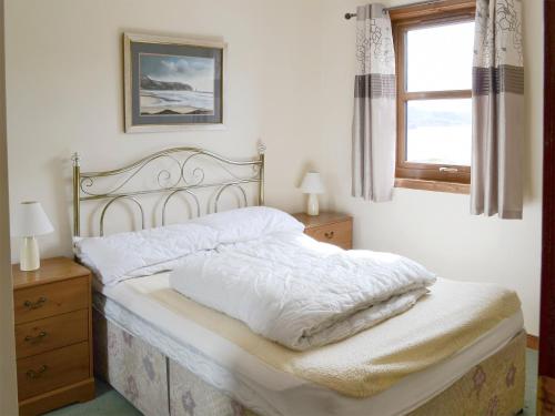 A bed or beds in a room at Lochinchard Cottages