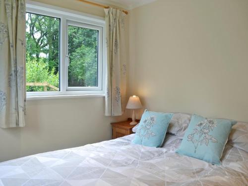 a bedroom with a bed and a window at Swallows Nest in Hoel-galed