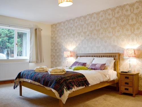 a bedroom with a bed with two towels on it at Castle View in Llanbadarn-fynydd