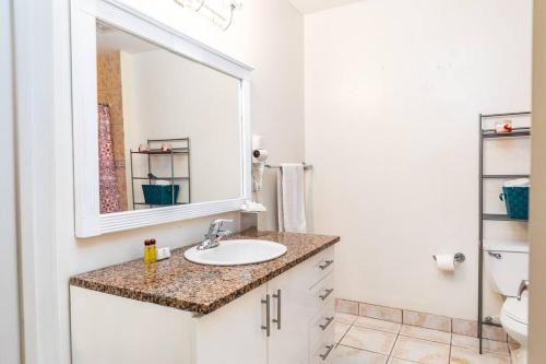 a bathroom with a sink and a mirror at Shore to Please - Large Studio Condo in Turtle Cove
