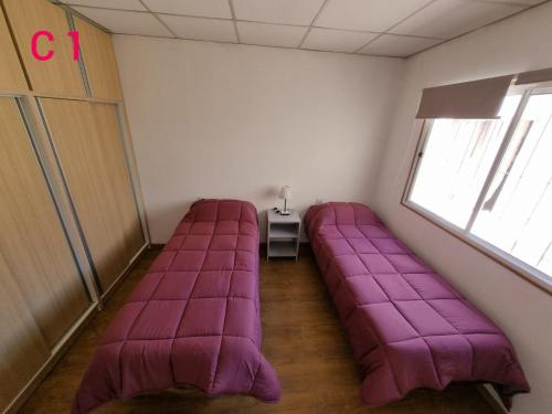 a room with a purple couch in the corner at FAMILY HOUSE MALARGUE in Malargüe