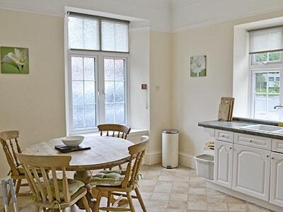 a kitchen with a table and chairs in a room at Silverdale Apartment in Lindale