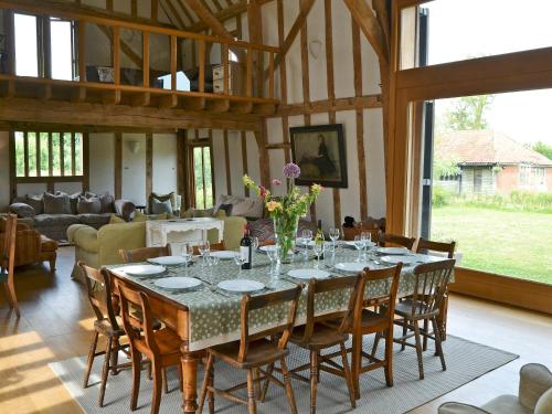 a large dining room with a table and chairs at Low Farm Barn in Laxfield