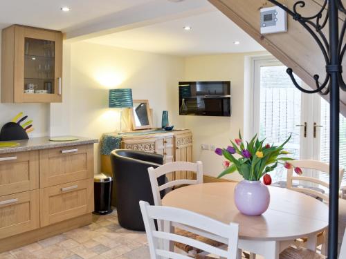 a kitchen and dining room with a table and chairs at The Boiler House in Osmotherley