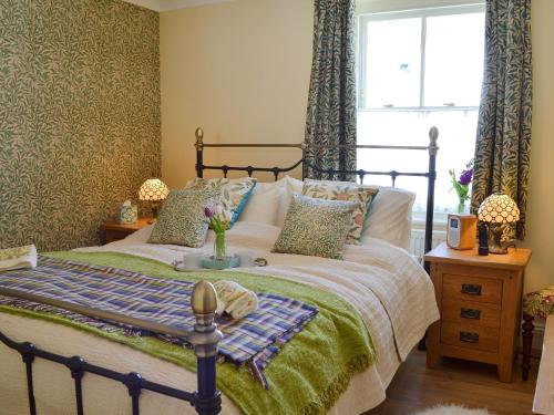 a bedroom with a bed and a window at Larkspur in Hollington