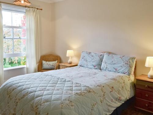 a bedroom with a bed and a window at Eastwyn in Winterton-on-Sea