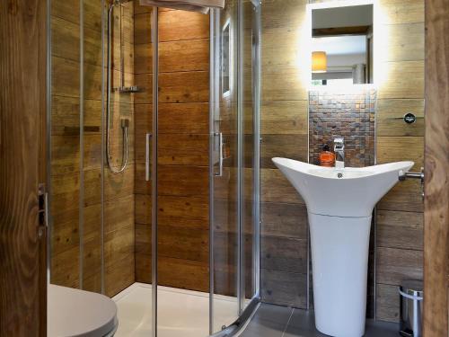 a bathroom with a sink and a shower at Glan-y-gors in Beddgelert