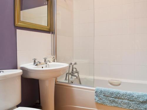 a bathroom with a sink and a toilet and a tub at The Stables in Martin