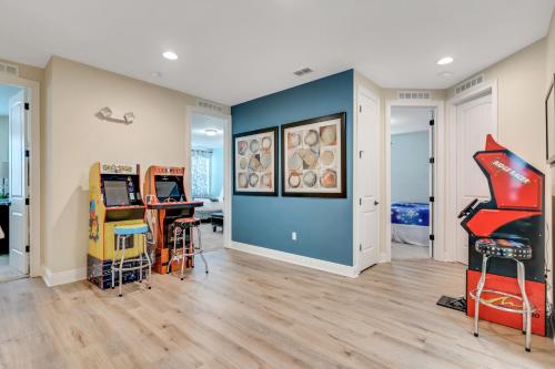 a room with a blue wall and a bunch of furniture at Huge 10 BDR Family House with Arcades and Free Pool Heat Near Disney in Orlando