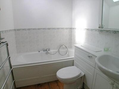 a bathroom with a toilet and a tub and a sink at Jemima Cottage in Saint Martins Green