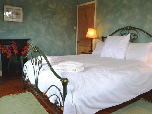 a bed with white sheets and pillows in a bedroom at Ryecroft in Windermere