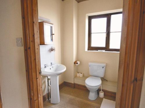 a bathroom with a toilet and a sink at Seacrest Cottage - Hw7746 in Pendine