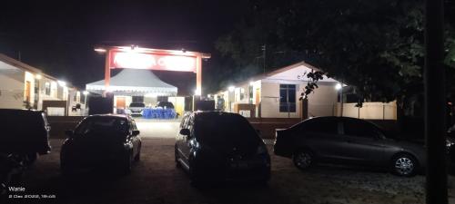 a group of cars parked in front of a gas station at night at Mutiara Chalet in Melaka