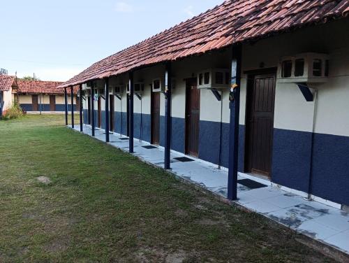 a row of houses with blue and white walls at Pousada Village Maçarico in Salinópolis