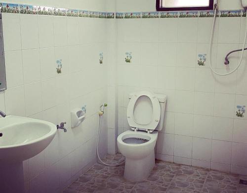 a bathroom with a toilet and a sink at LPL Resort in Chiang Mai