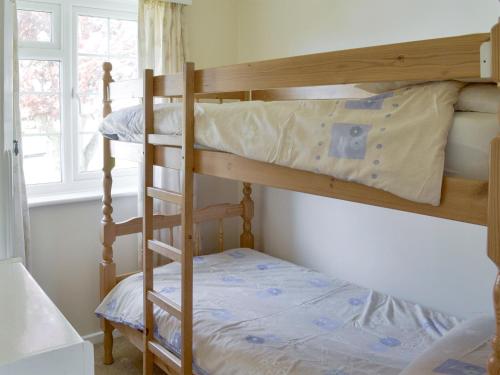 a bunk bed room with two bunk beds in a room at Dene Corner in Stokenham